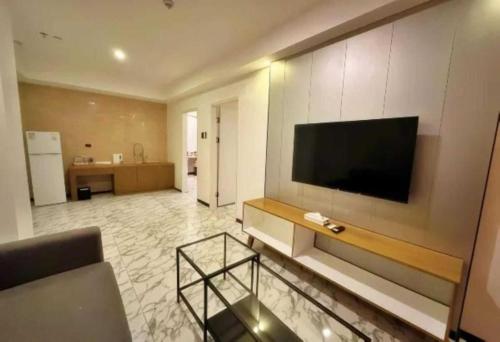a living room with a flat screen tv on a wall at Sunday Hevea Hotel and Resort in Angeles