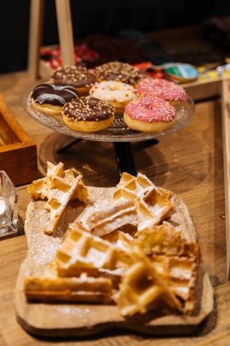 a table with two trays of pastries and donuts at Boutique Hotel Azur in De Haan