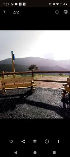 two wooden benches sitting on the side of a road at ALOJAMIENTO TURISTICO LAS SOLANERAS in Solana del Pino