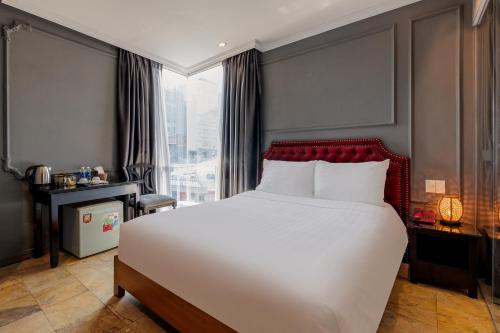 a bedroom with a large bed and a large window at Collection O Le Grand Hanoi hotel - The Sun in Hanoi