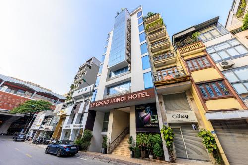 a building with a hotel on the side of a street at Collection O Le Grand Hanoi hotel - The Sun in Hanoi