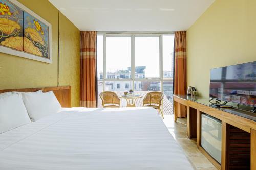 a hotel room with a large bed and a television at Collection O Le Grand Hanoi hotel - The Sun in Hanoi