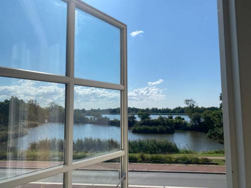 a view of a lake from a window at Villa in the center with Seaview in Nakskov