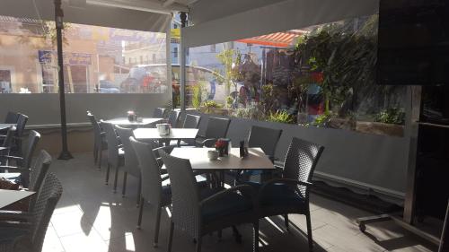 a row of tables and chairs in a restaurant at Hotel Creta Paguera in Paguera