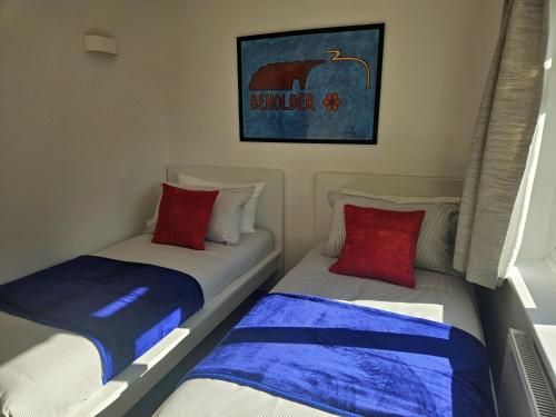 two beds sitting next to each other in a room at The Glen in Hythe