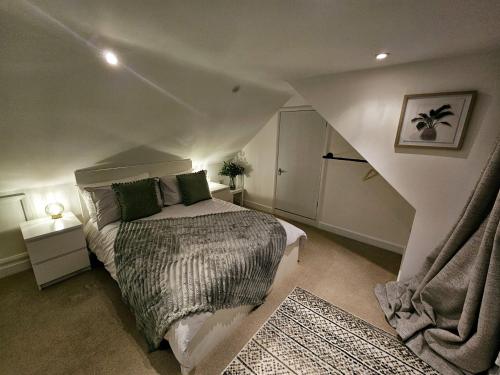 a bedroom with a large bed in a attic at The Glen in Hythe