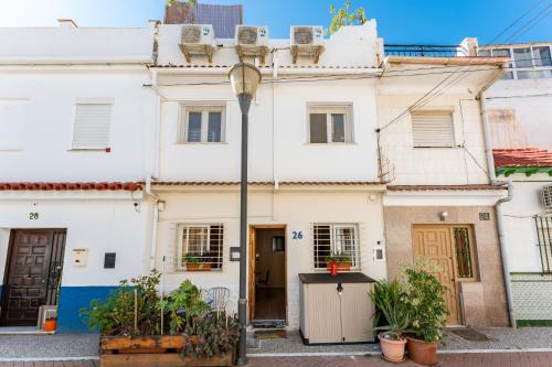 a white house with plants in front of it at Sunset House in Málaga
