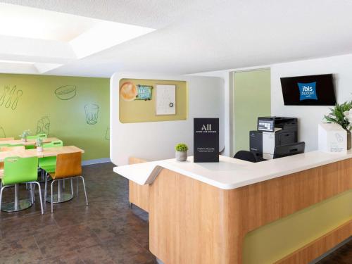 a waiting room with a counter and a table at ibis Budget - Campbelltown in Campbelltown