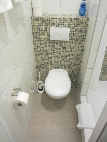 a small bathroom with a toilet and a sink at Aurelia Rooms in Mostar