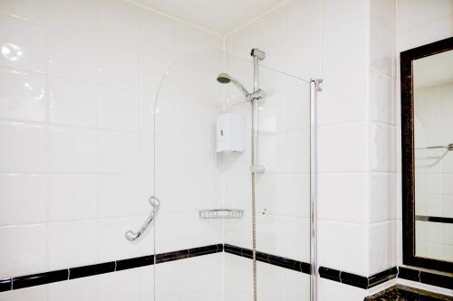 a bathroom with a shower with a glass door at Warwickshire Park Hotel Kenilworth by Belvilla in Kenilworth