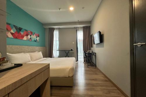 a hotel room with a bed and a television at OYO Townhouse, Selayang formerly RHR Hotel in Batu Caves