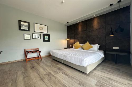 a bedroom with a large white bed and a wooden floor at OYO Townhouse, Selayang formerly RHR Hotel in Batu Caves