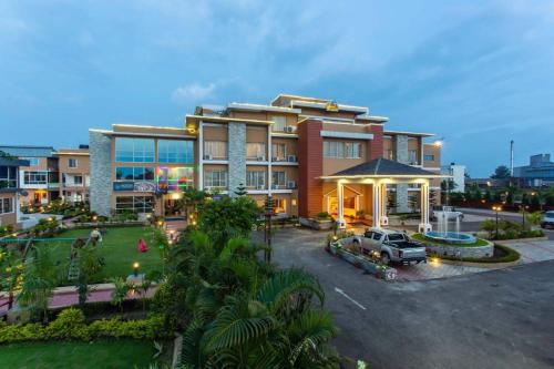 a large building with a parking lot in front of it at Palette 823 Hotel Ichchha in Simara