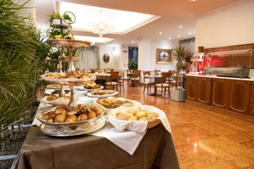a buffet of food on a table in a kitchen at Hotel Stendhal in Parma