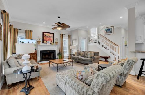 a living room with two couches and a fireplace at Grand Pavilion 29 by Wild Dunes in Isle of Palms