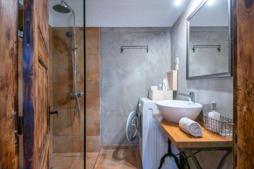 a bathroom with a glass shower and a sink at Gioma Garden Villas in Istron