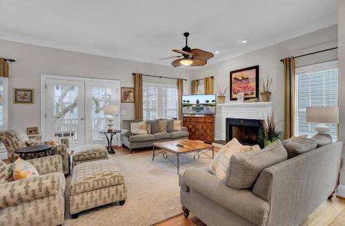 a living room with couches and a fireplace at Grand Pavilion 29 by Wild Dunes in Isle of Palms