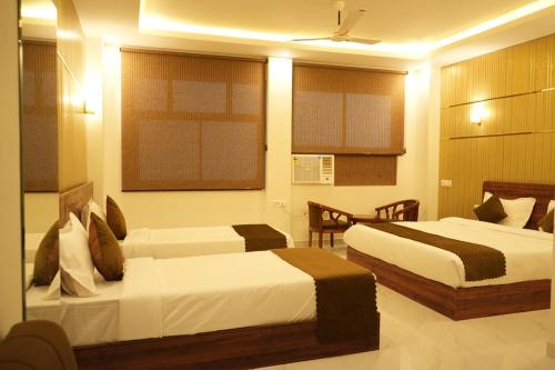a hotel room with two beds in a room at Hotel Golden Palace in Lucknow