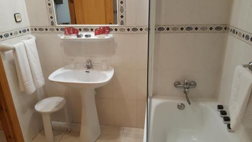 a bathroom with a sink and a toilet and a shower at Hotel Torre De Los Guzmanes in La Algaba
