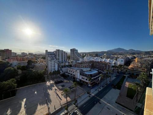 a view of a city with buildings and palm trees at Paz y relax junto al mar in El Campello