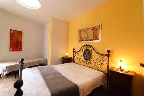 a bedroom with two beds with yellow walls at Casa Samira Otranto Near Sea and Old Town AC, WiFi, 4 Guests in Otranto