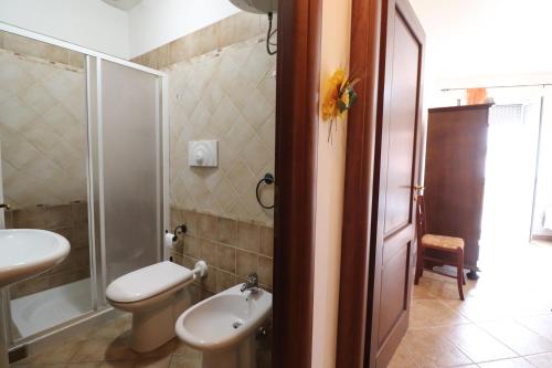 a bathroom with a toilet and a sink and a shower at Casa Samira Otranto Near Sea and Old Town AC, WiFi, 4 Guests in Otranto