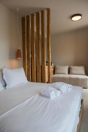 a bedroom with two beds with towels on them at Gioma Garden Villas in Istron