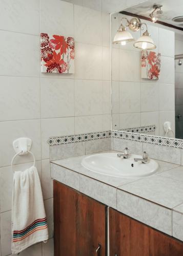 a bathroom with a sink and a mirror at Letona Guesthouse in Kuruman