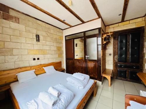 a bedroom with a bed with white pillows on it at Rooms43 in Sofia