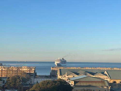 a cruise ship in the ocean next to a city at Casanova Bluelife in Trieste