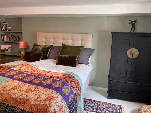 a bedroom with a large bed and a dresser at Relaxing accommodation in the central of Trosa in Trosa