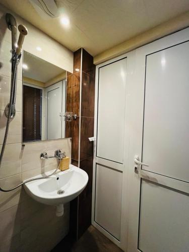 a bathroom with a sink and a shower at Rooms43 in Sofia