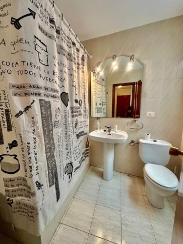 a bathroom with a sink and a toilet and a mirror at Apartamento de vistabella REF 015 in Vistabella del Maestrazgo