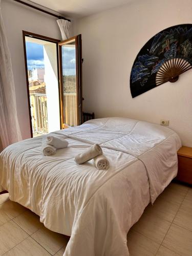 a bedroom with a bed with towels on it at Apartamento de vistabella REF 015 in Vistabella del Maestrazgo