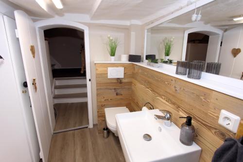 a bathroom with a white sink and a toilet at Ferienhaus Charlotte in Goslar