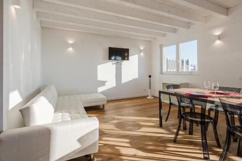 a living room with a white couch and a table at Casanova Bluelife in Trieste
