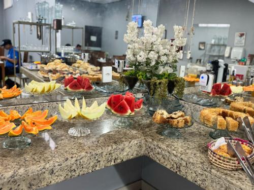 a buffet with many plates of food on a counter at Big Hotel in Imperatriz