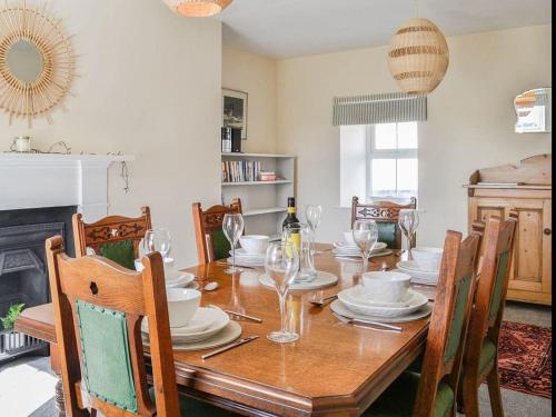 a dining room with a wooden table and chairs at Blackloch in Gatehouse of Fleet