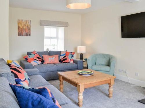 a living room with a couch and a coffee table at Blackloch in Gatehouse of Fleet