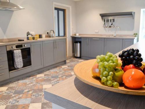 a kitchen with a plate of fruit on a table at Blackloch in Gatehouse of Fleet