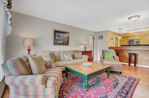 a living room with two couches and a coffee table at Lagoon Villas 13 by Wild Dunes, with Amenities in Isle of Palms