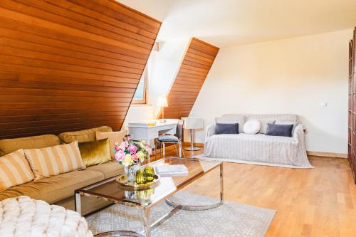 a living room with a couch and a table at Hotel Kaiserhof in Anif