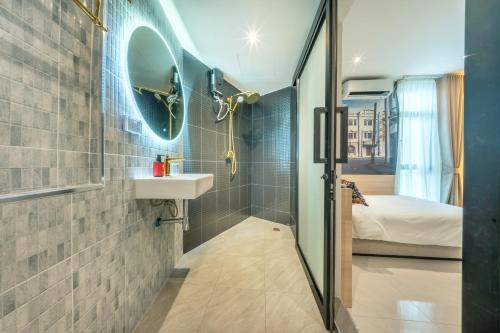 a bathroom with a sink and a mirror at U TOR Yaowarat in Bangkok