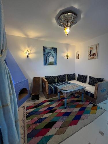 a living room with a couch and a table at Casa Blue Star in Chefchaouene