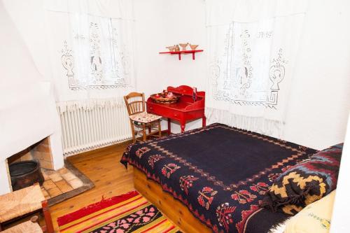 a bedroom with a bed and a red desk at 260m2 Unique mountain house in Lilea Parnasos in Lílaia