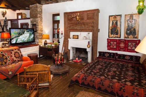 a living room with a bed and a fireplace at 260m2 Unique mountain house in Lilea Parnasos in Lílaia
