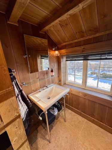 a bathroom with a sink and a window at Geilo - Charming cottage with a stunning view in Geilo
