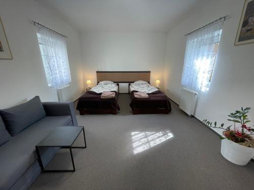 a living room with two beds and a couch at Apartmán Štěpánka in Jihlava
