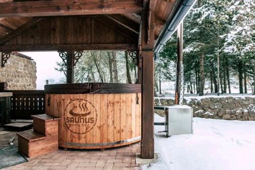a large wooden barrel sitting under a pavilion at Chata Margit - Margit-lak in Szalóc