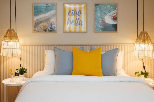 a bedroom with a bed with blue and yellow pillows at Magnolia Inn in Panama City